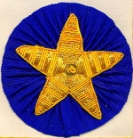 Gilt or Silver Stars on Rosettes on Apron (per pair)